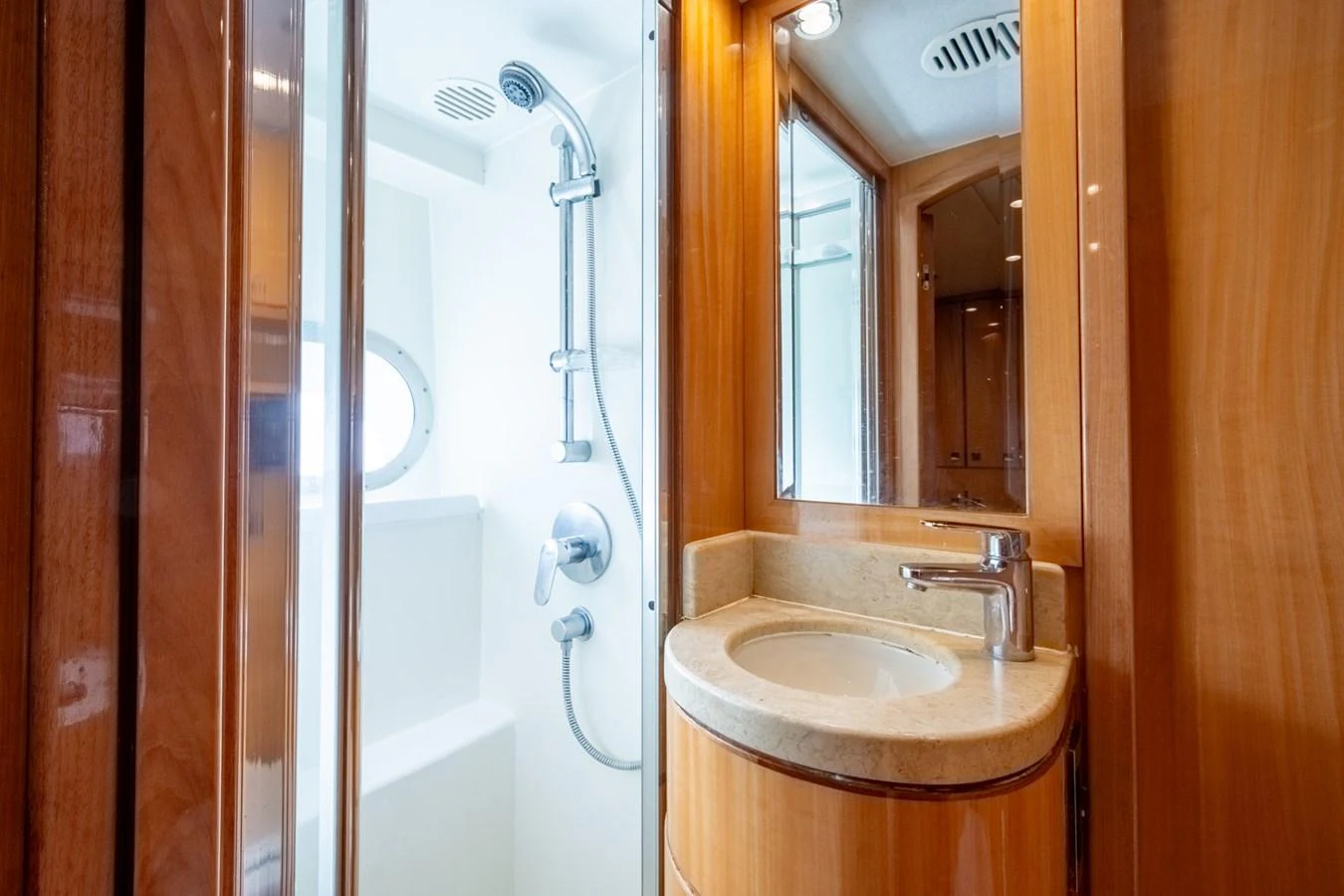 A sleek and modern yacht bathroom with a shower and vanity. aboard LUCKY PENNY Yacht for Sale