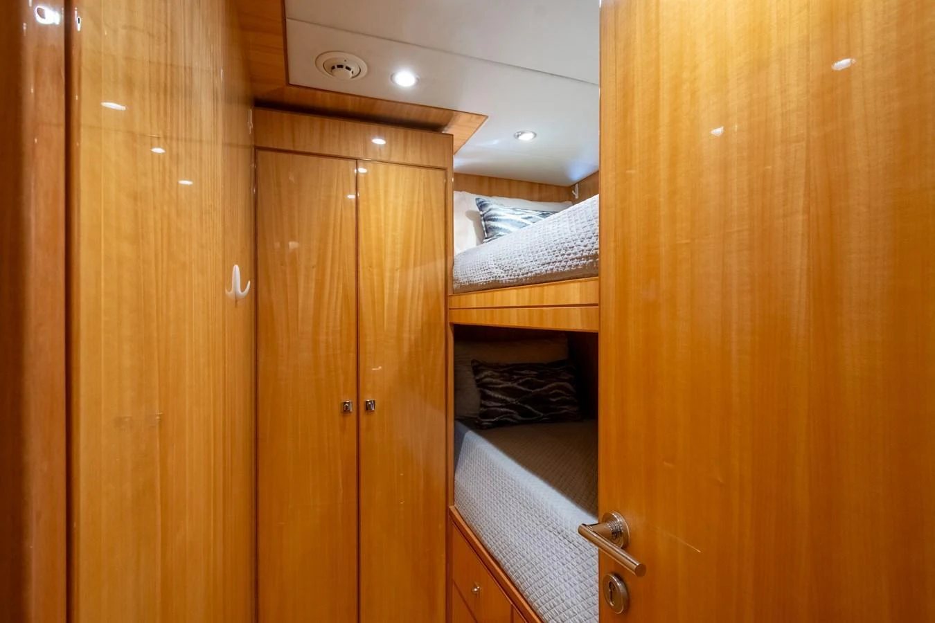 The guest cabin features cozy bunk beds with warm wooden finishes. aboard LUCKY PENNY Yacht for Sale
