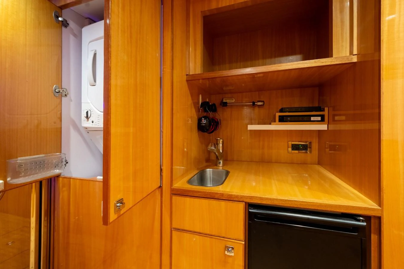 The compact galley features wooden cabinetry, a small sink, and essential appliances. aboard LUCKY PENNY Yacht for Sale