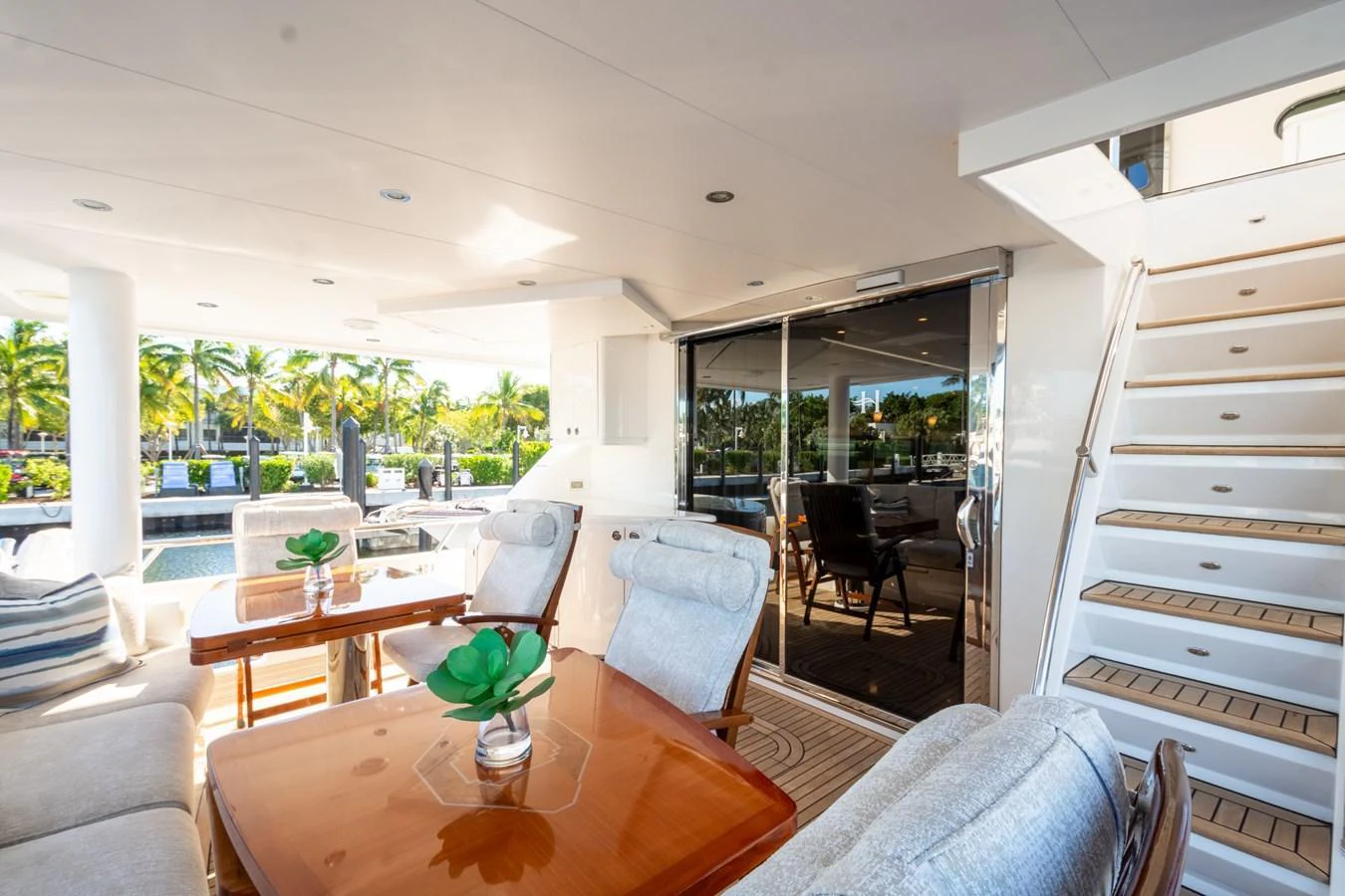 The aft deck features a comfortable seating area with a dining table, perfect for alfresco dining and relaxation. aboard LUCKY PENNY Yacht for Sale