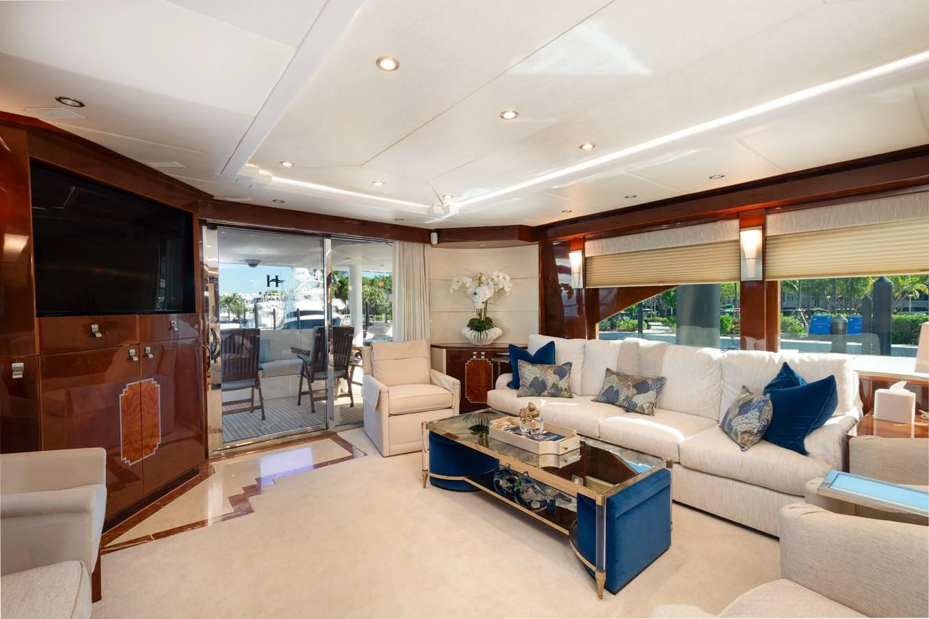 The yacht's salon features luxurious seating and elegant decor with ample natural light. aboard LUCKY PENNY Yacht for Sale