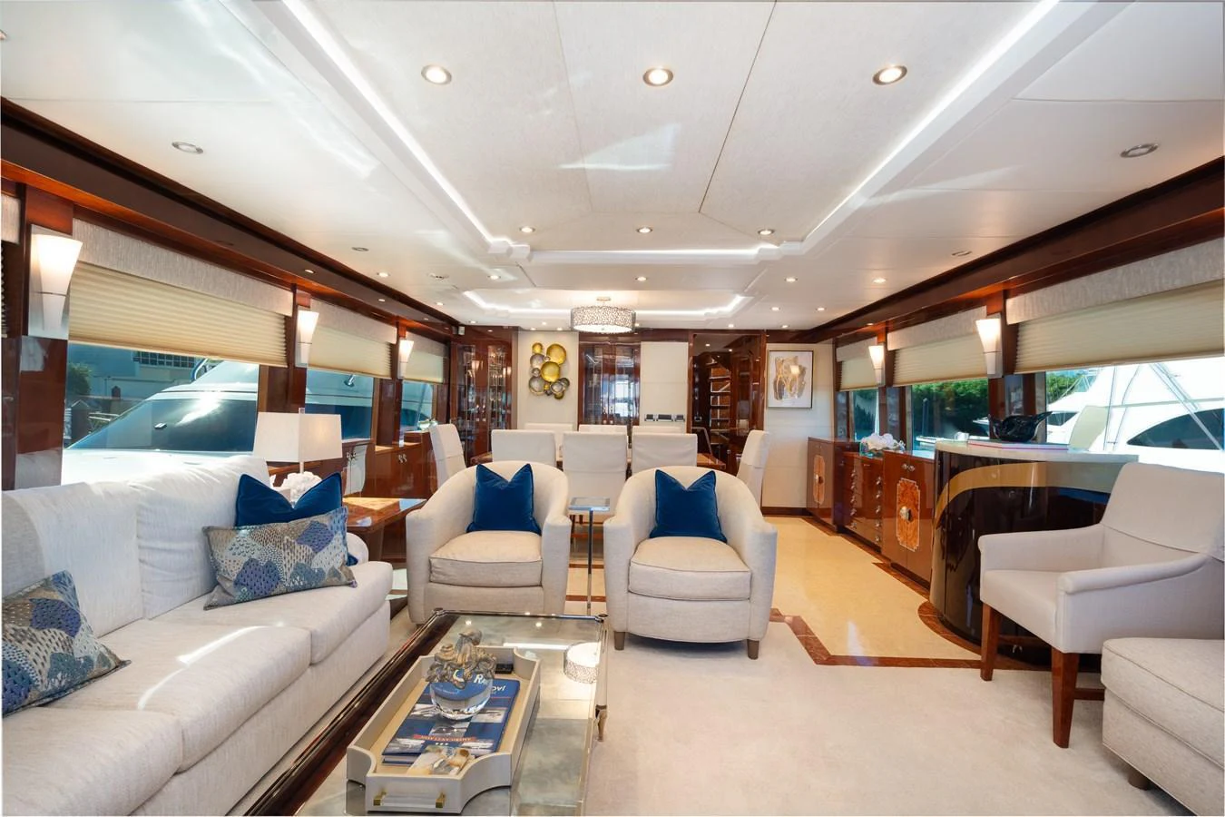 The salon features elegant seating with plush furnishings and ample natural light. aboard LUCKY PENNY Yacht for Sale