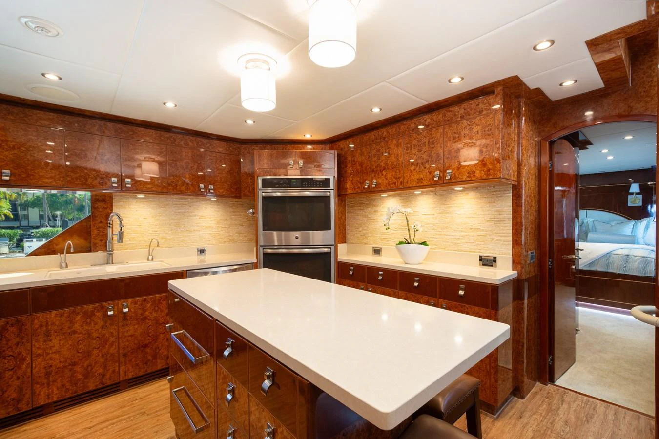 The galley features rich wood cabinetry, modern appliances, and a spacious island for meal preparation. aboard LUCKY PENNY Yacht for Sale