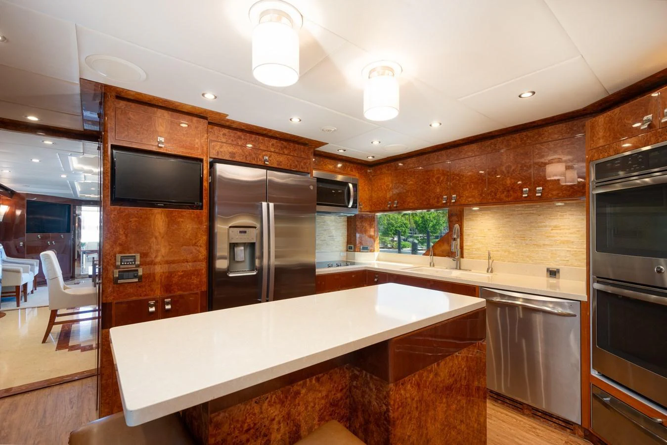 The yacht's galley features modern stainless steel appliances and a sleek, polished design. aboard LUCKY PENNY Yacht for Sale
