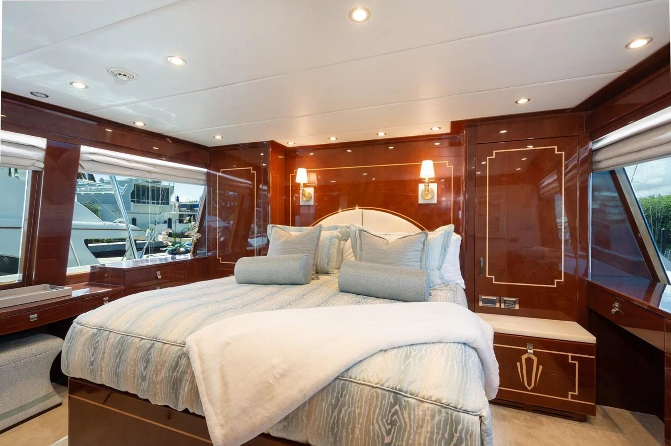 The stateroom features a luxurious bed with plush bedding and elegant wood paneling. aboard LUCKY PENNY Yacht for Sale