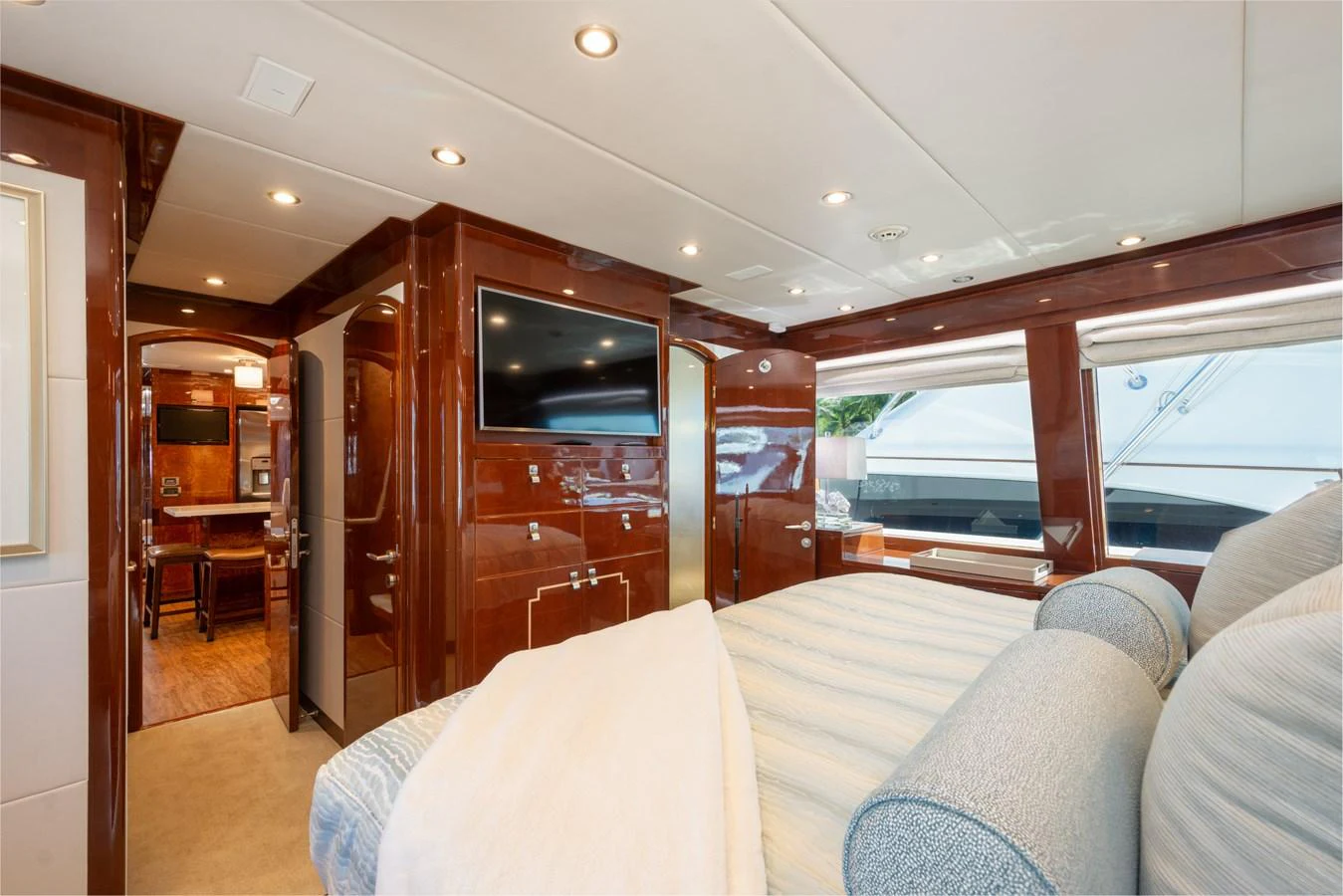 The stateroom features luxurious bedding, rich wood finishes, and ample natural light. aboard LUCKY PENNY Yacht for Sale