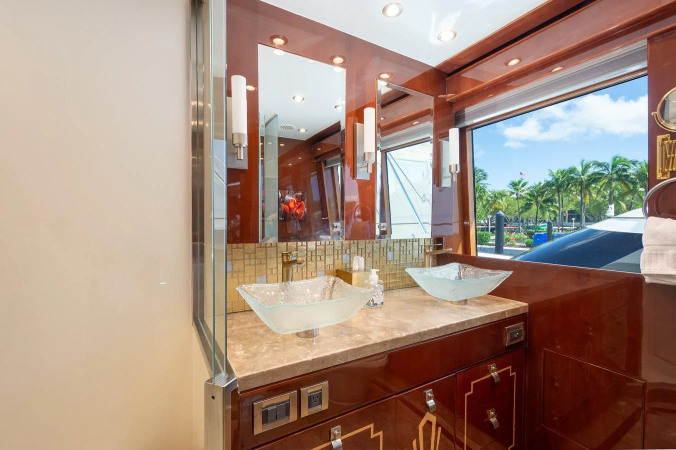 The yacht's bathroom features elegant fixtures and a large window with a view. aboard LUCKY PENNY Yacht for Sale