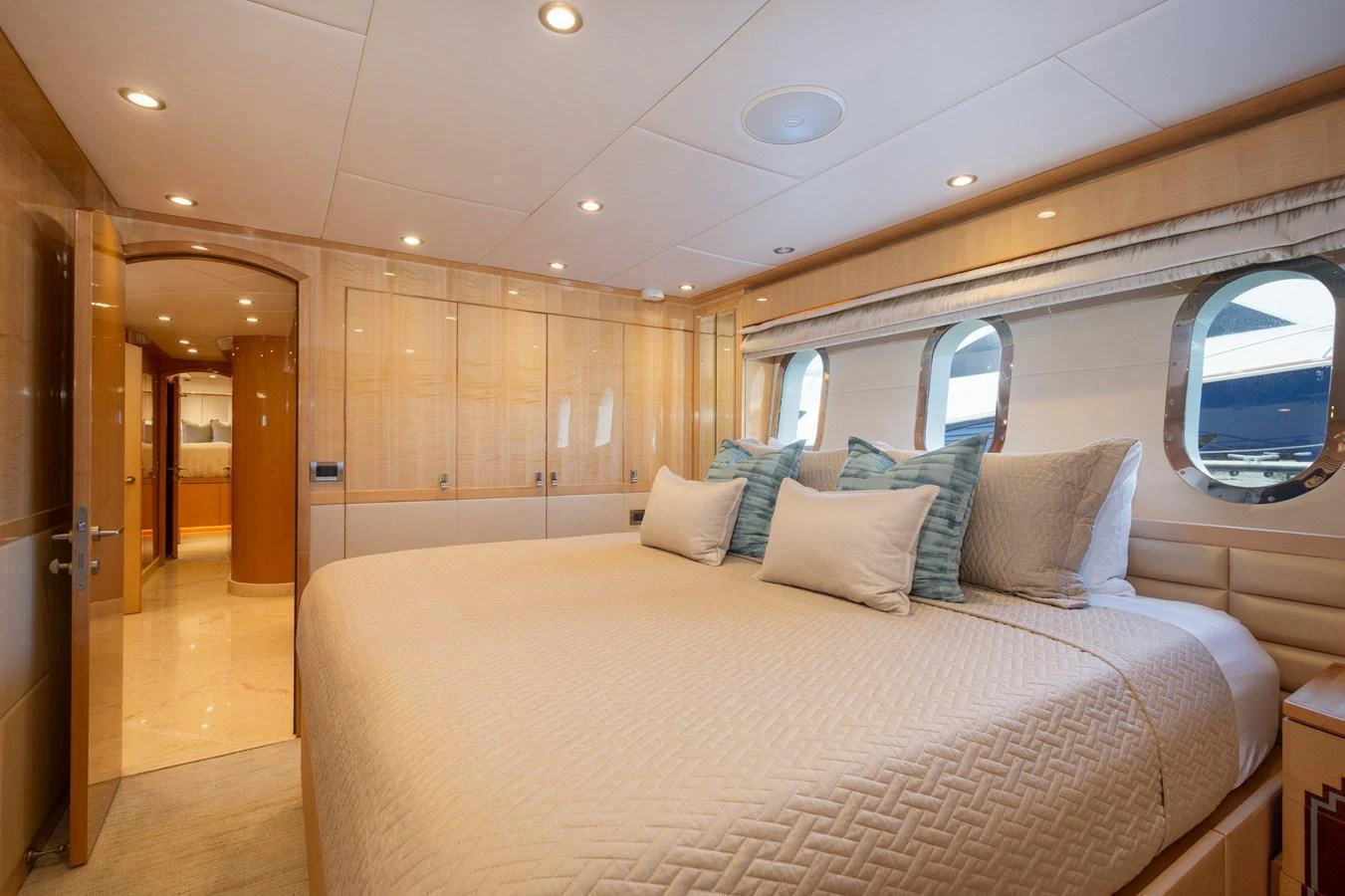 The master stateroom features a luxurious bed with ample natural light from the large windows. aboard LUCKY PENNY Yacht for Sale