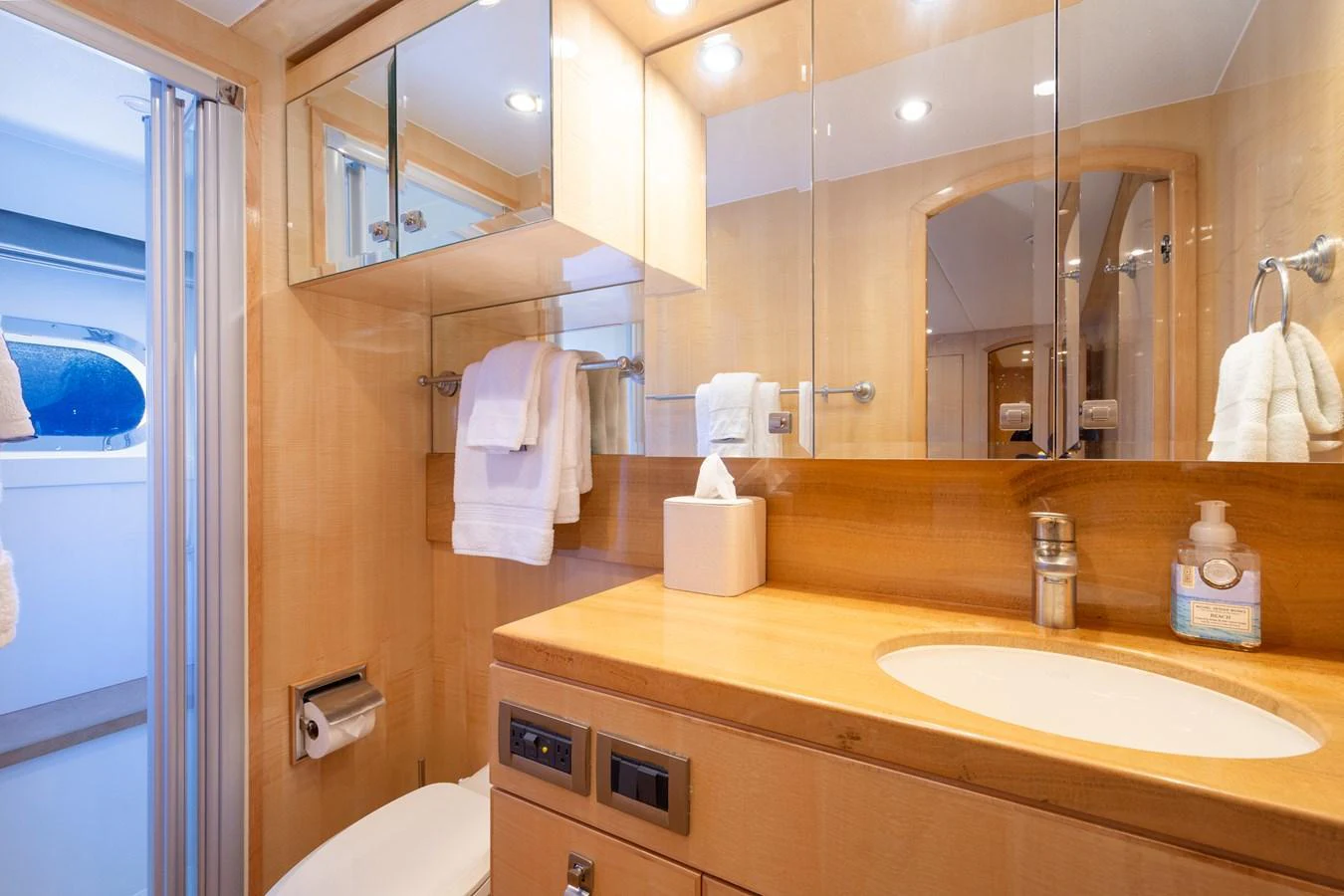 The yacht's bathroom features a sleek design with ample storage and modern fixtures. aboard LUCKY PENNY Yacht for Sale