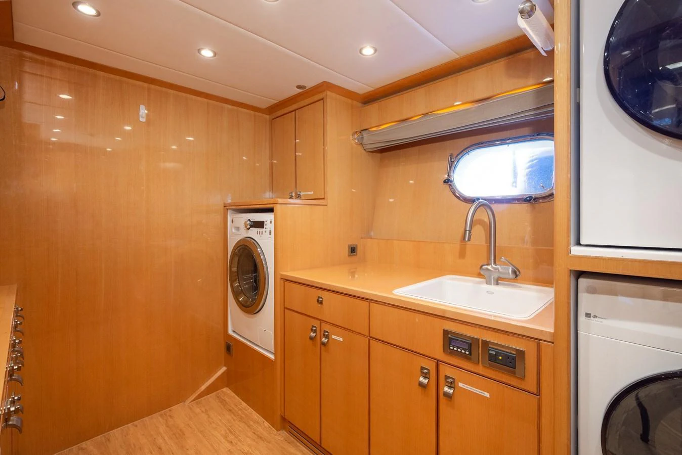 The yacht's laundry room features modern appliances and ample storage in a well-lit space. aboard LUCKY PENNY Yacht for Sale