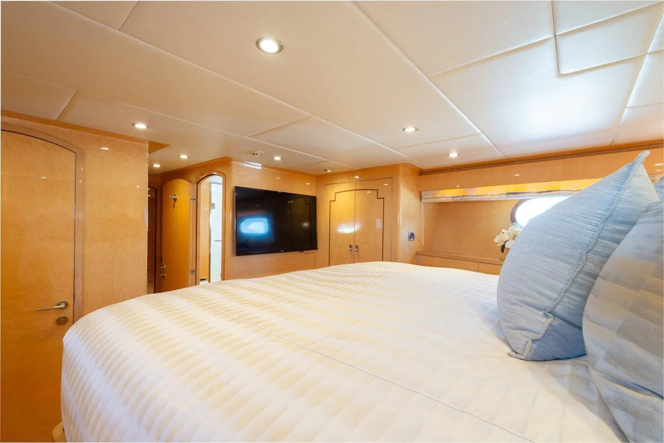 The stateroom features a plush bed with elegant bedding and ample natural light. aboard LUCKY PENNY Yacht for Sale