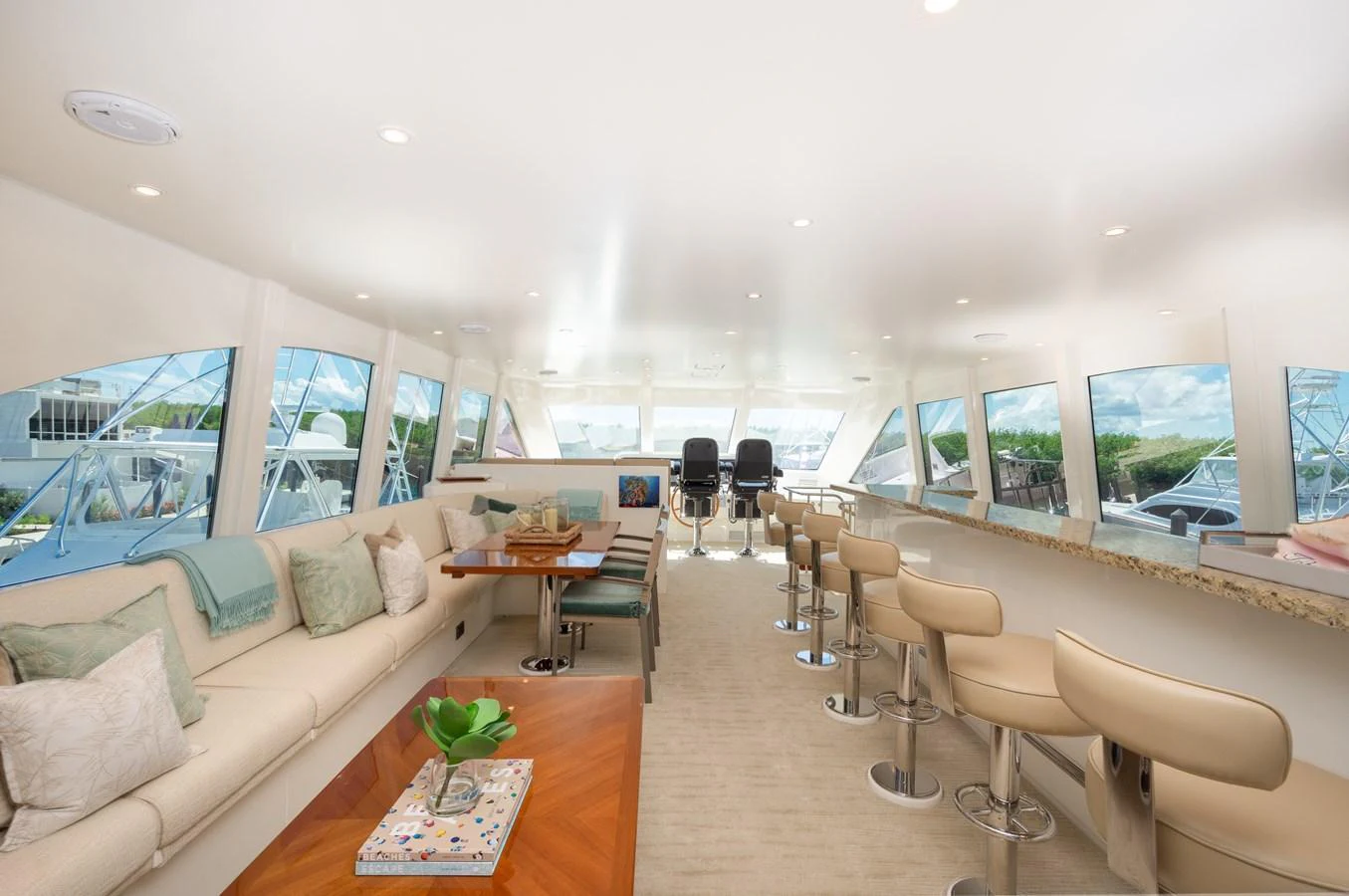 The spacious salon features elegant seating, a bar area, and large windows offering panoramic views. aboard LUCKY PENNY Yacht for Sale