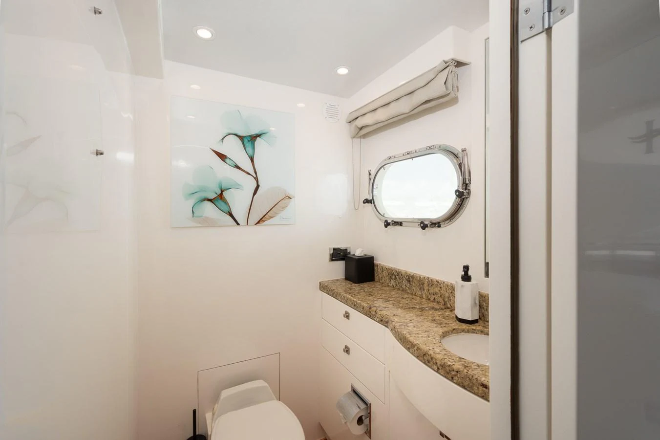 The yacht's bathroom features a sleek design with a granite countertop and modern fixtures. aboard LUCKY PENNY Yacht for Sale