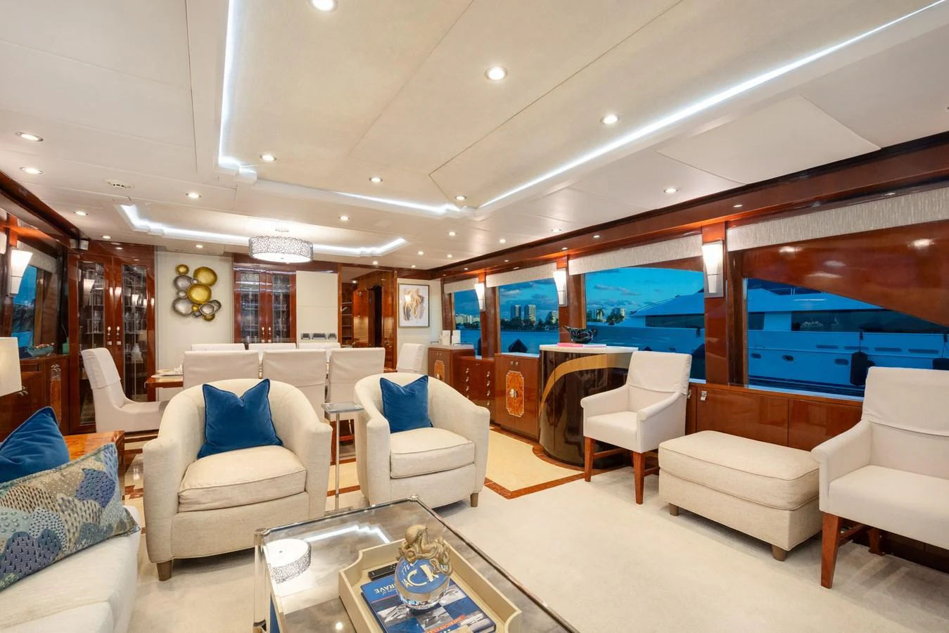 The yacht's salon features luxurious seating and elegant decor with large windows offering stunning views. aboard LUCKY PENNY Yacht for Sale