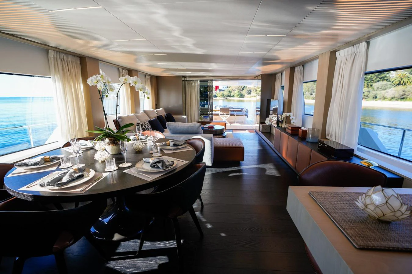 a living room with a large table and chairs aboard TORO Yacht for Sale