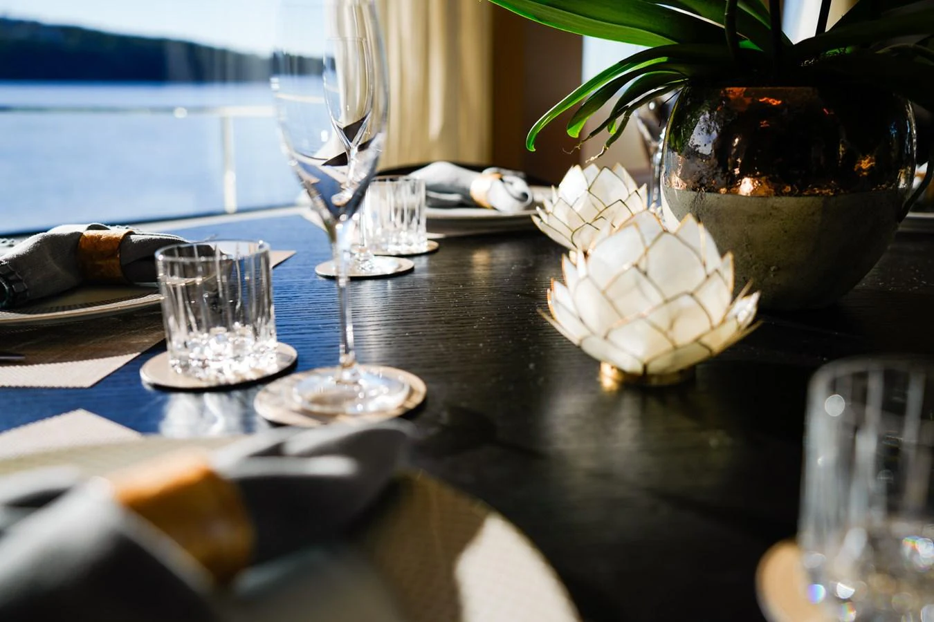 a table with a plant and glasses on it aboard TORO Yacht for Sale