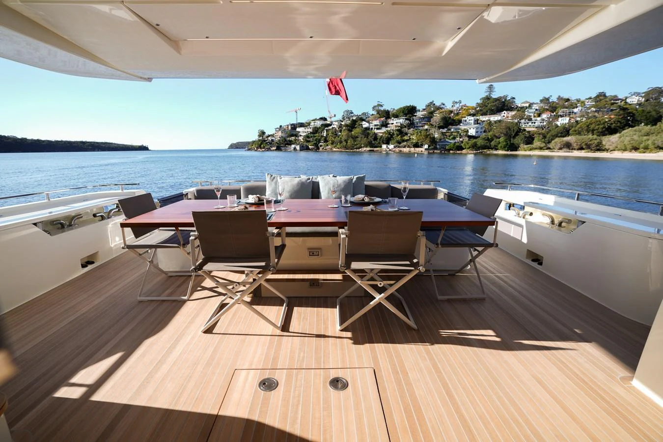 a deck with chairs and a table on it aboard TORO Yacht for Sale