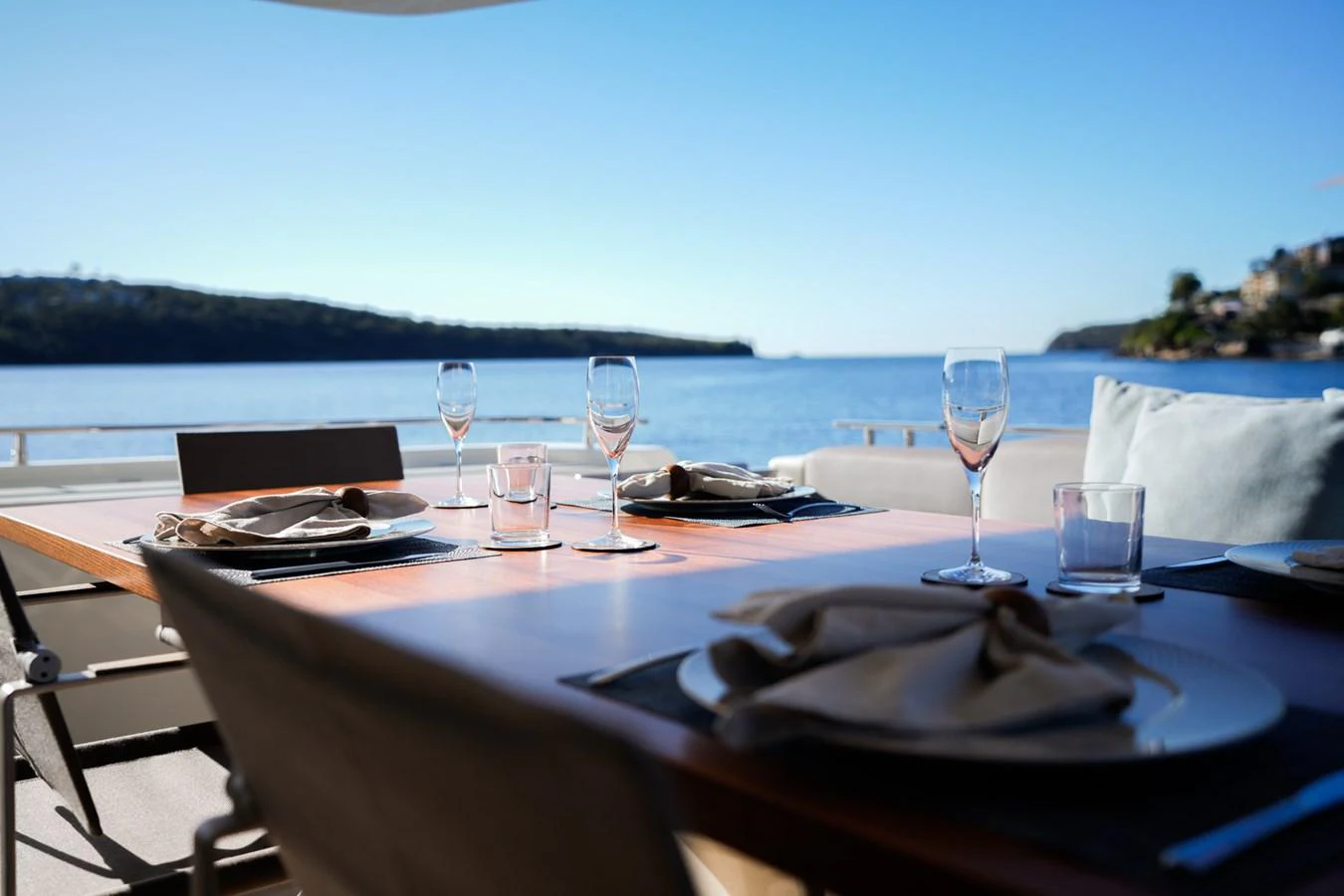 a table with glasses and plates on it aboard TORO Yacht for Sale