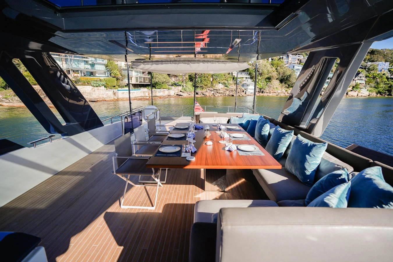 a deck with a table and chairs aboard TORO Yacht for Sale