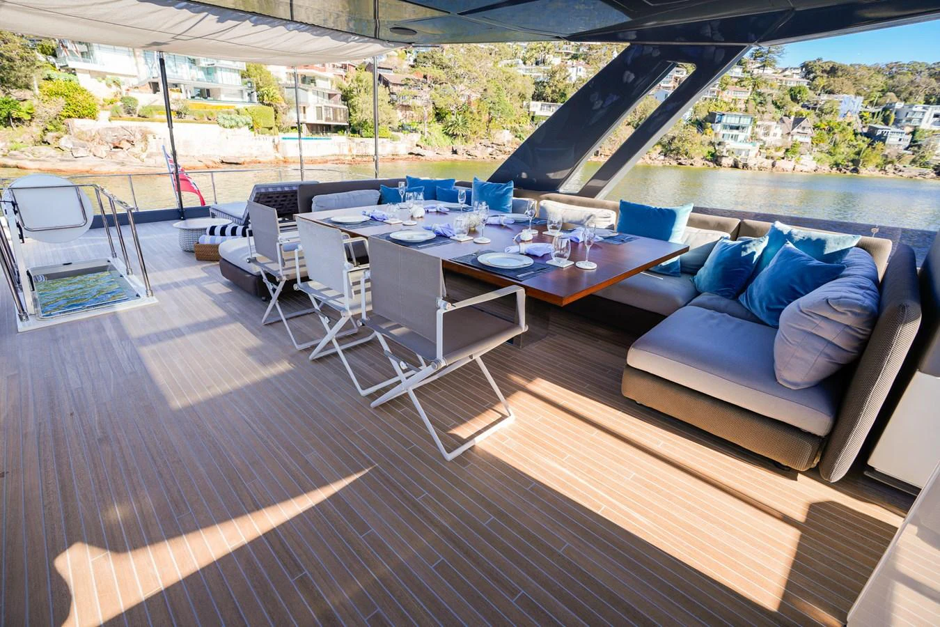 a patio with a couch and a table and chairs aboard TORO Yacht for Sale