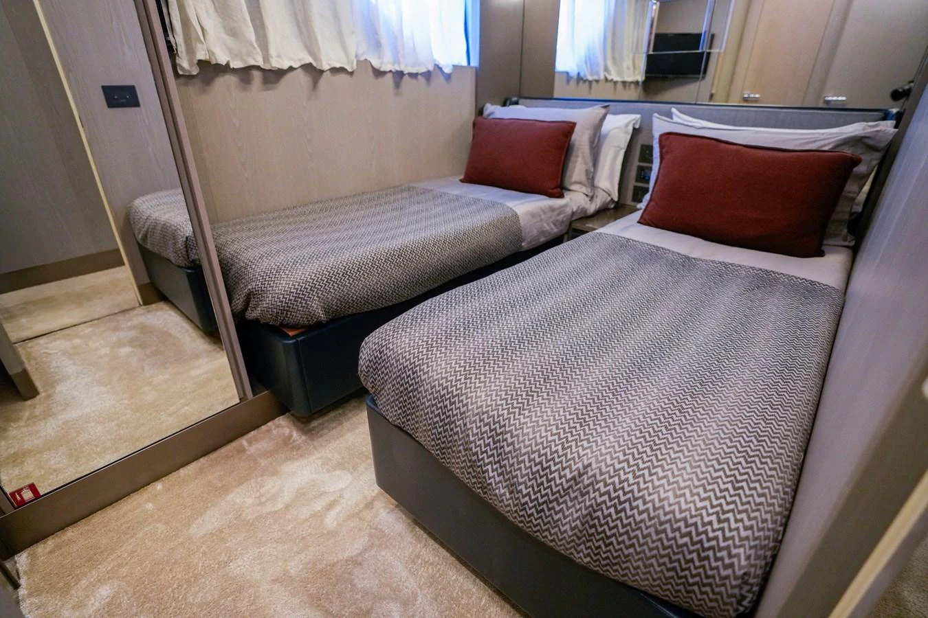 a bed with red pillows aboard TORO Yacht for Sale