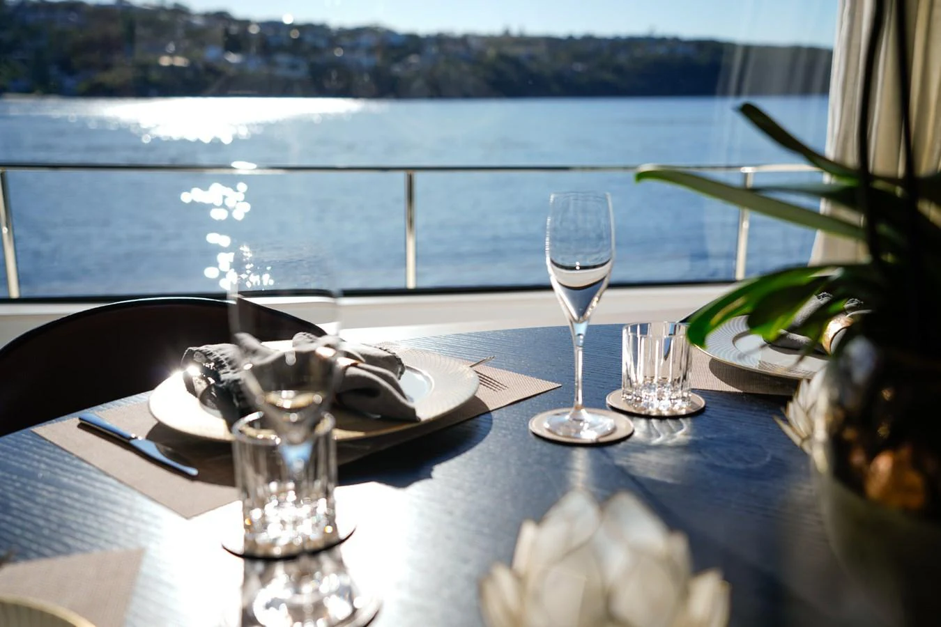 a table with glasses and a plate of food on it aboard TORO Yacht for Sale
