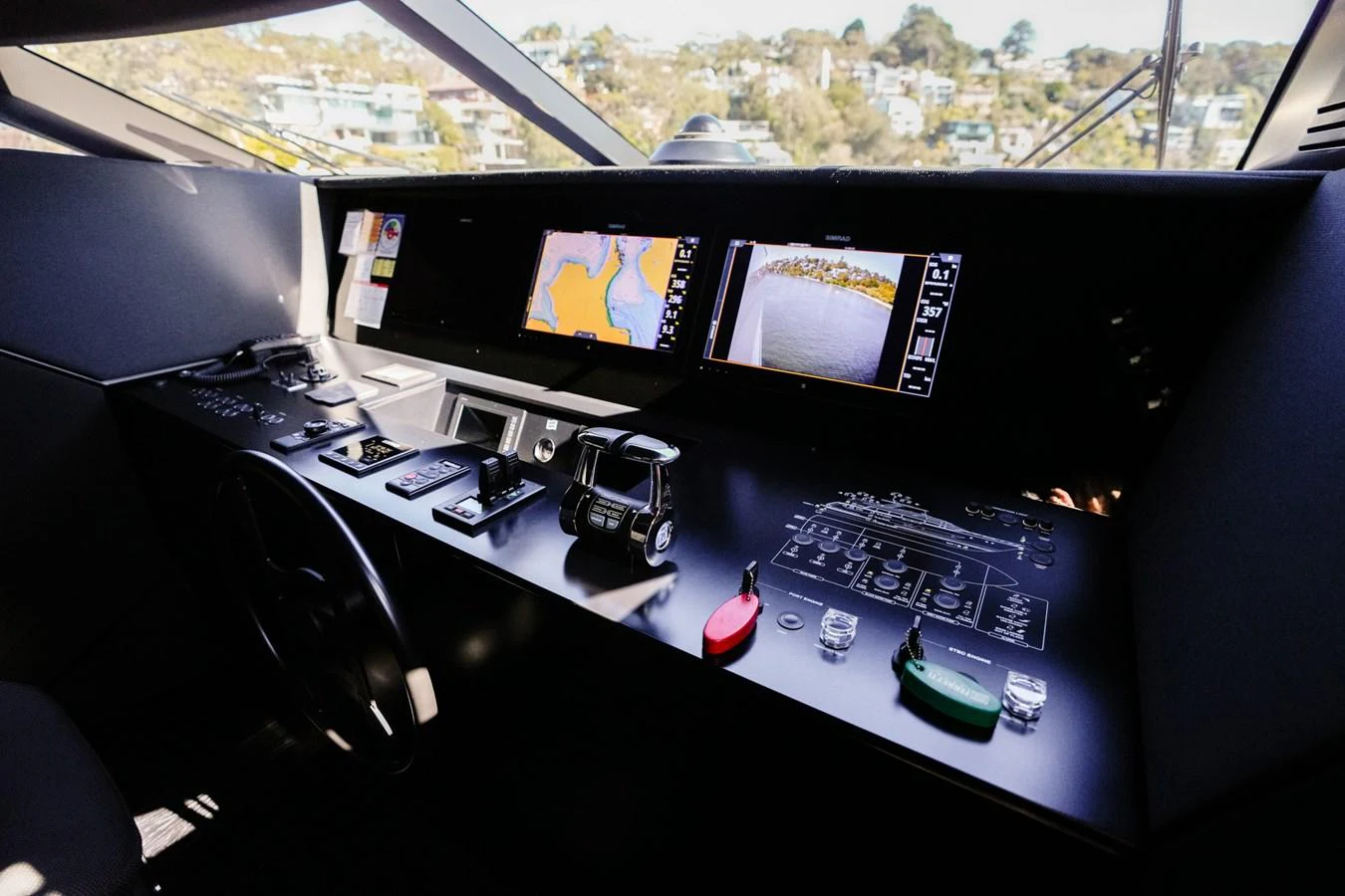 a desk with multiple monitors and a keyboard on it aboard TORO Yacht for Sale