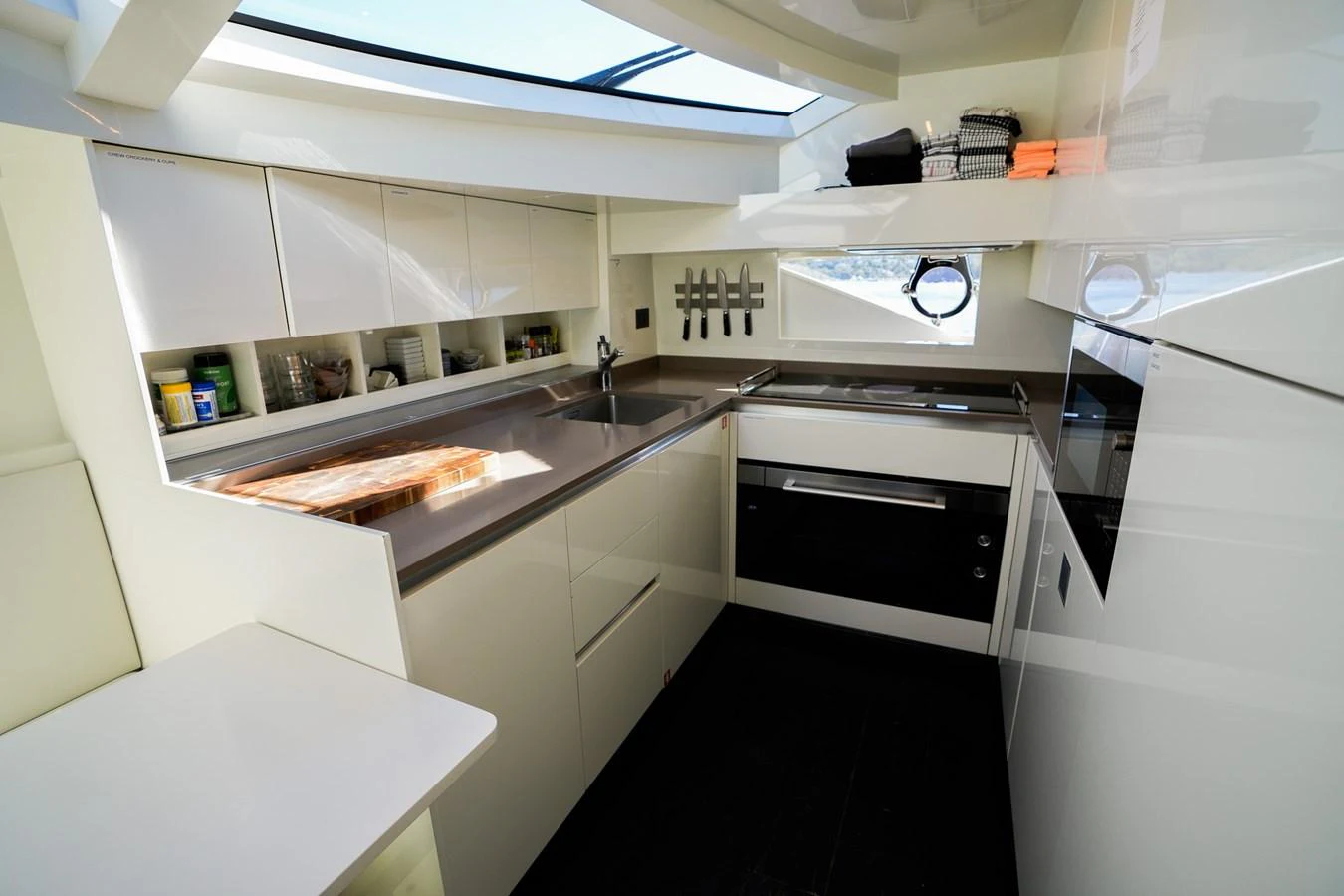 a kitchen with white cabinets aboard TORO Yacht for Sale