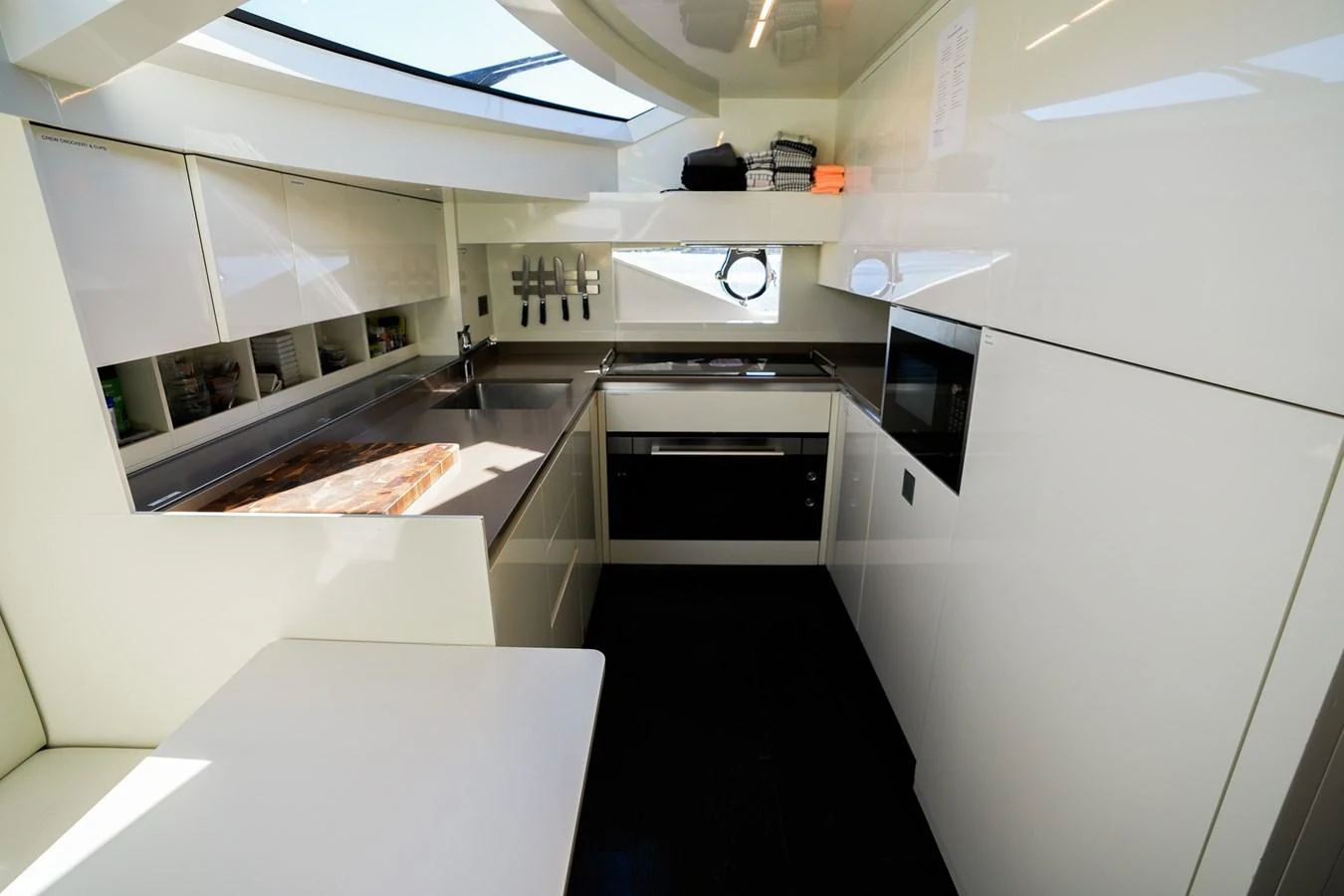 a kitchen with white cabinets aboard TORO Yacht for Sale