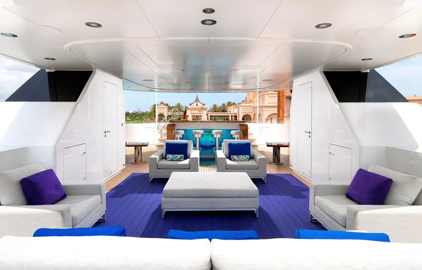 The sundeck features a spacious and elegant seating area with modern furnishings and vibrant accents. aboard JUST J'S Yacht for Sale