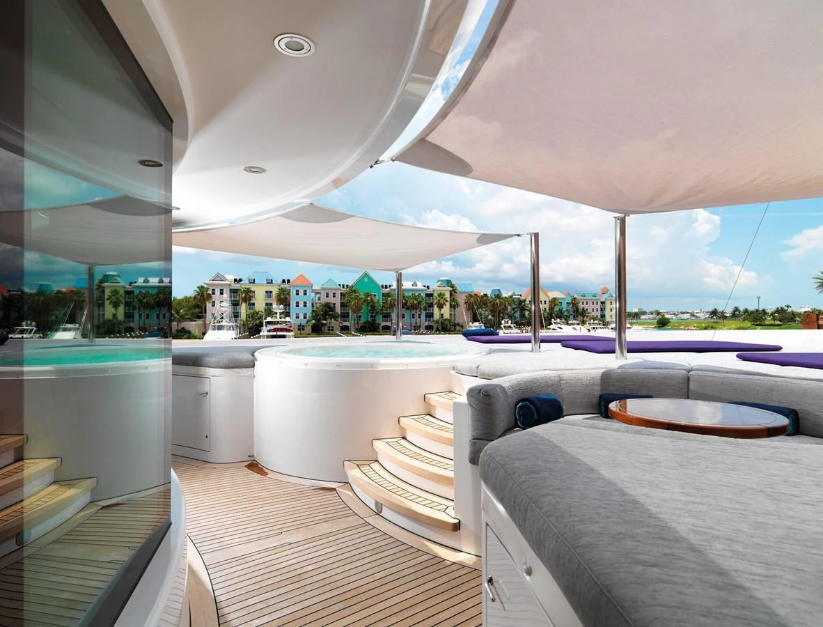 The sundeck features a luxurious jacuzzi and comfortable seating area under shade sails, perfect for relaxation. aboard JUST J'S Yacht for Sale