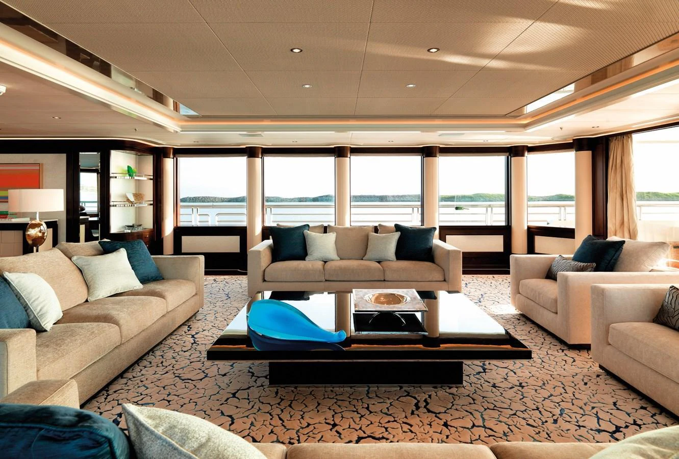 The spacious salon features elegant furnishings and panoramic windows with stunning views. aboard JUST J'S Yacht for Sale