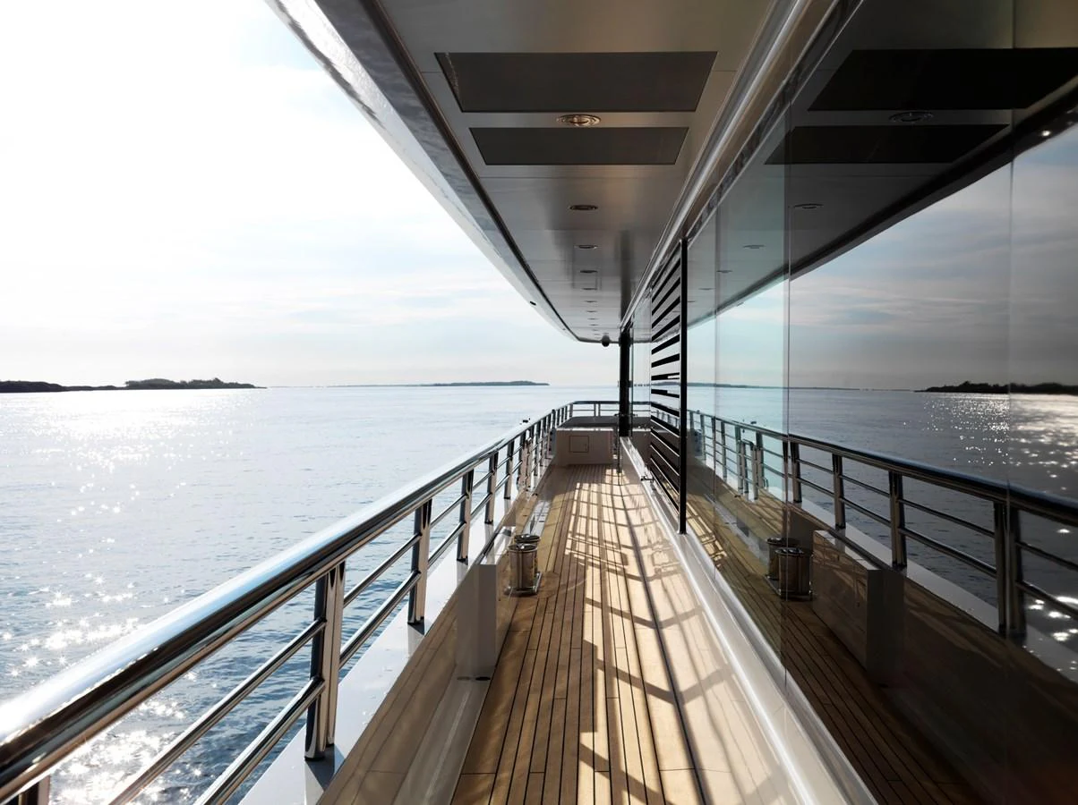The side deck offers a serene walkway with stunning ocean views and sleek modern design. aboard JUST J'S Yacht for Sale