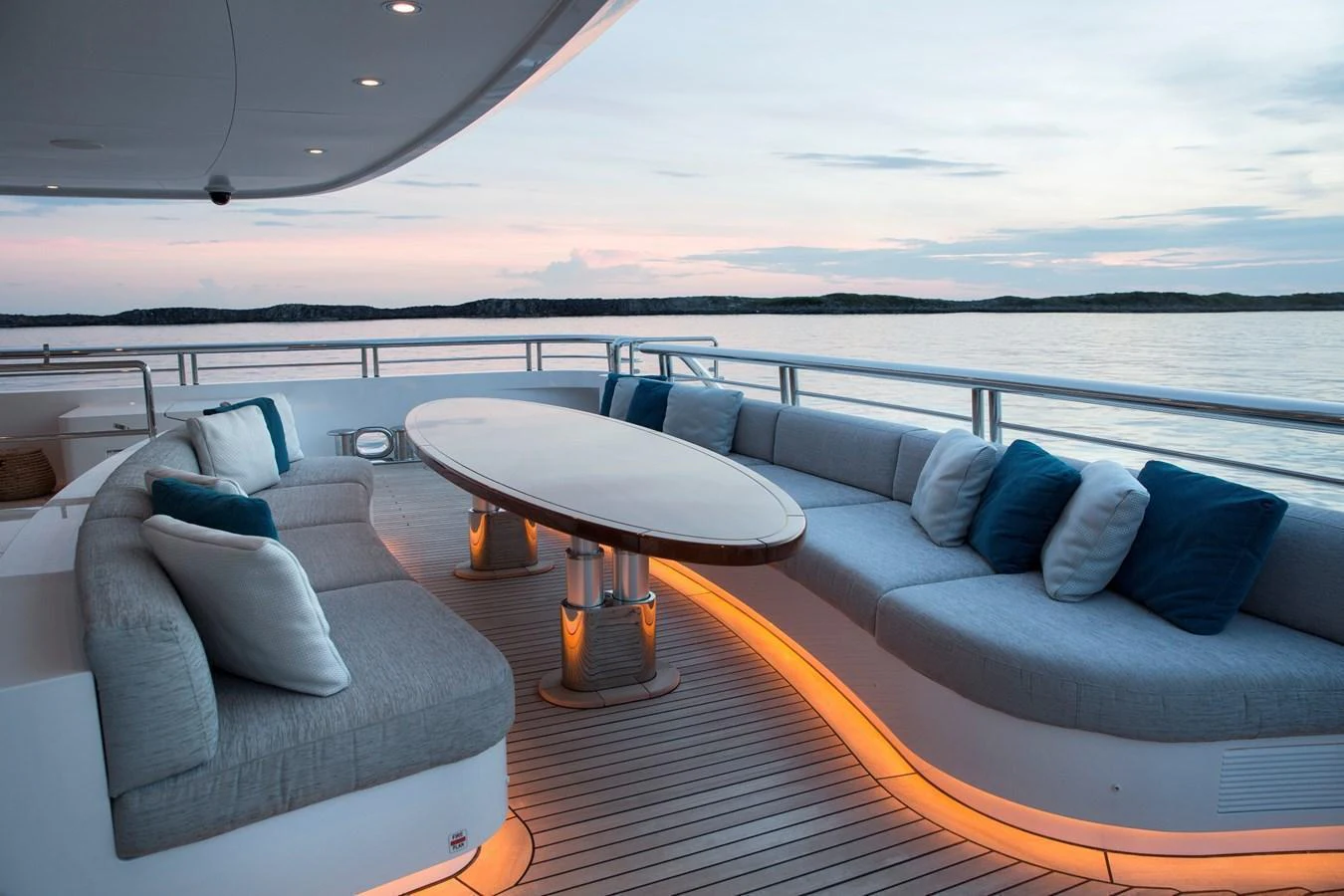 The aft deck features a stylish seating area with a central table, perfect for relaxing and enjoying the view. aboard JUST J'S Yacht for Sale
