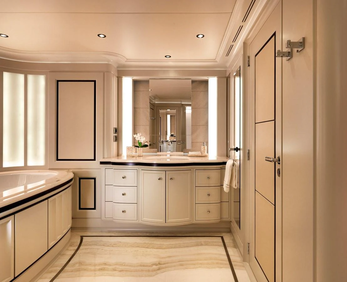The yacht's bathroom features elegant cabinetry and a luxurious bathtub, creating a serene and sophisticated atmosphere. aboard JUST J'S Yacht for Sale