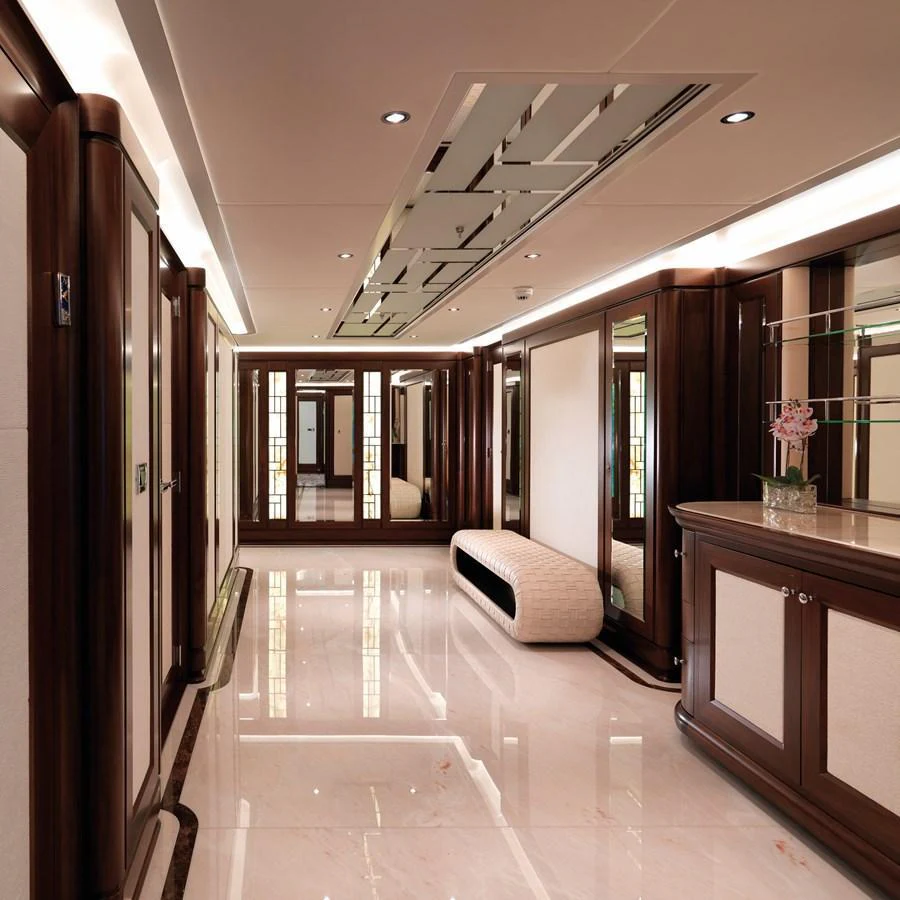 The yacht's interior features a luxurious hallway with elegant wood paneling and polished marble floors. aboard JUST J'S Yacht for Sale
