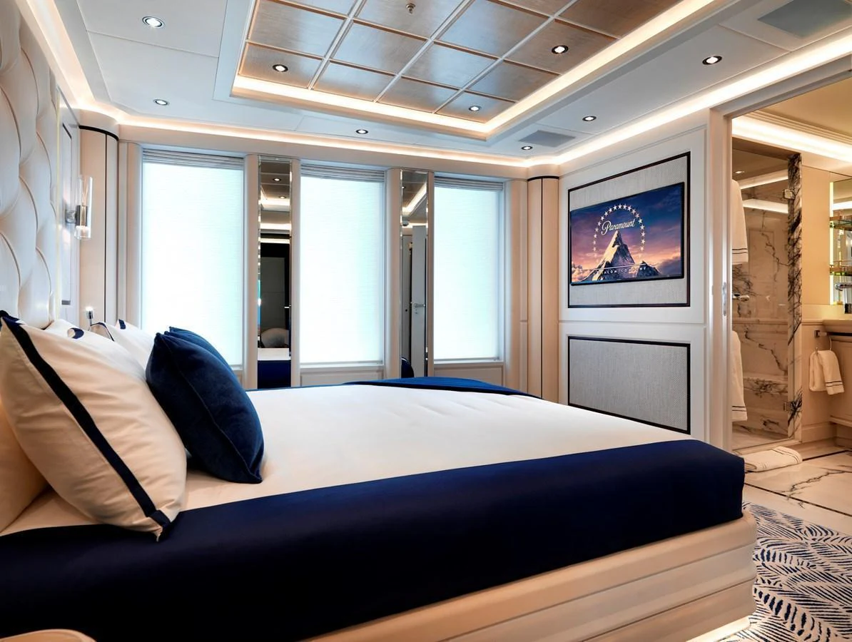 A luxurious stateroom featuring a large bed with plush bedding and modern decor. aboard JUST J'S Yacht for Sale