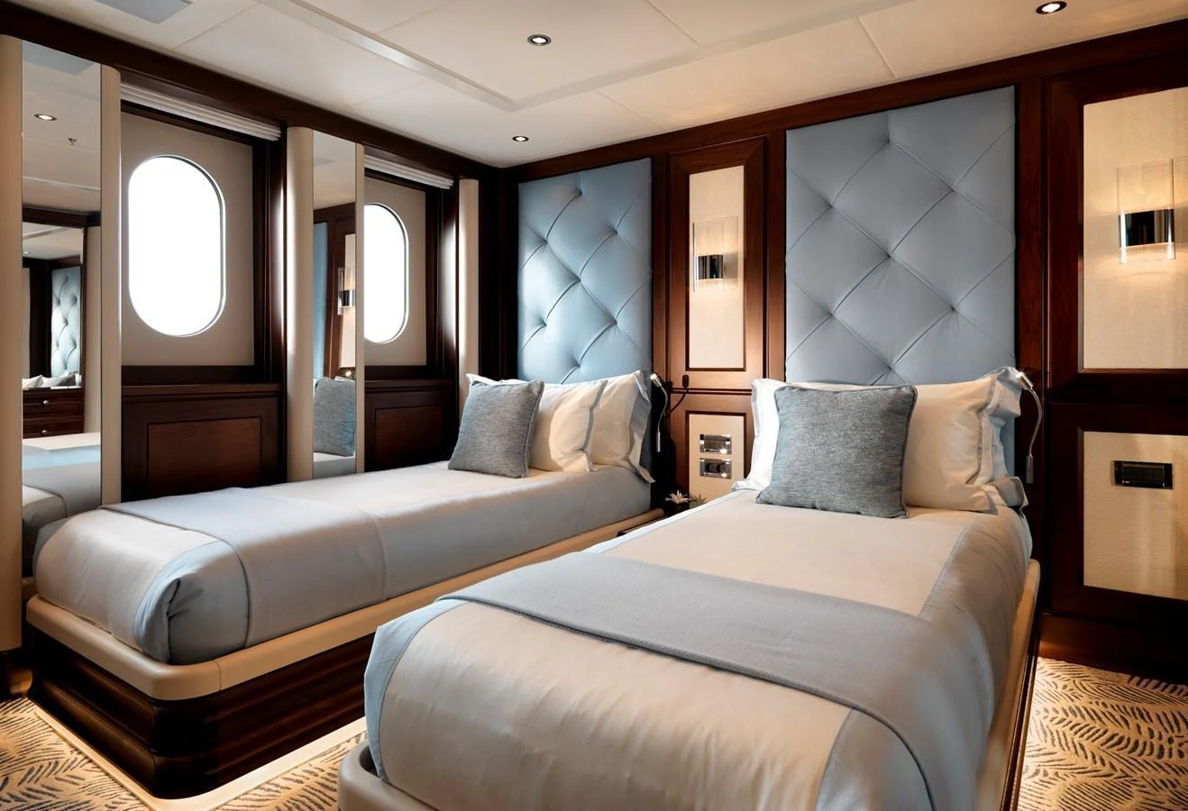 The twin stateroom features elegant bedding and luxurious finishes, creating a serene and inviting atmosphere. aboard JUST J'S Yacht for Sale