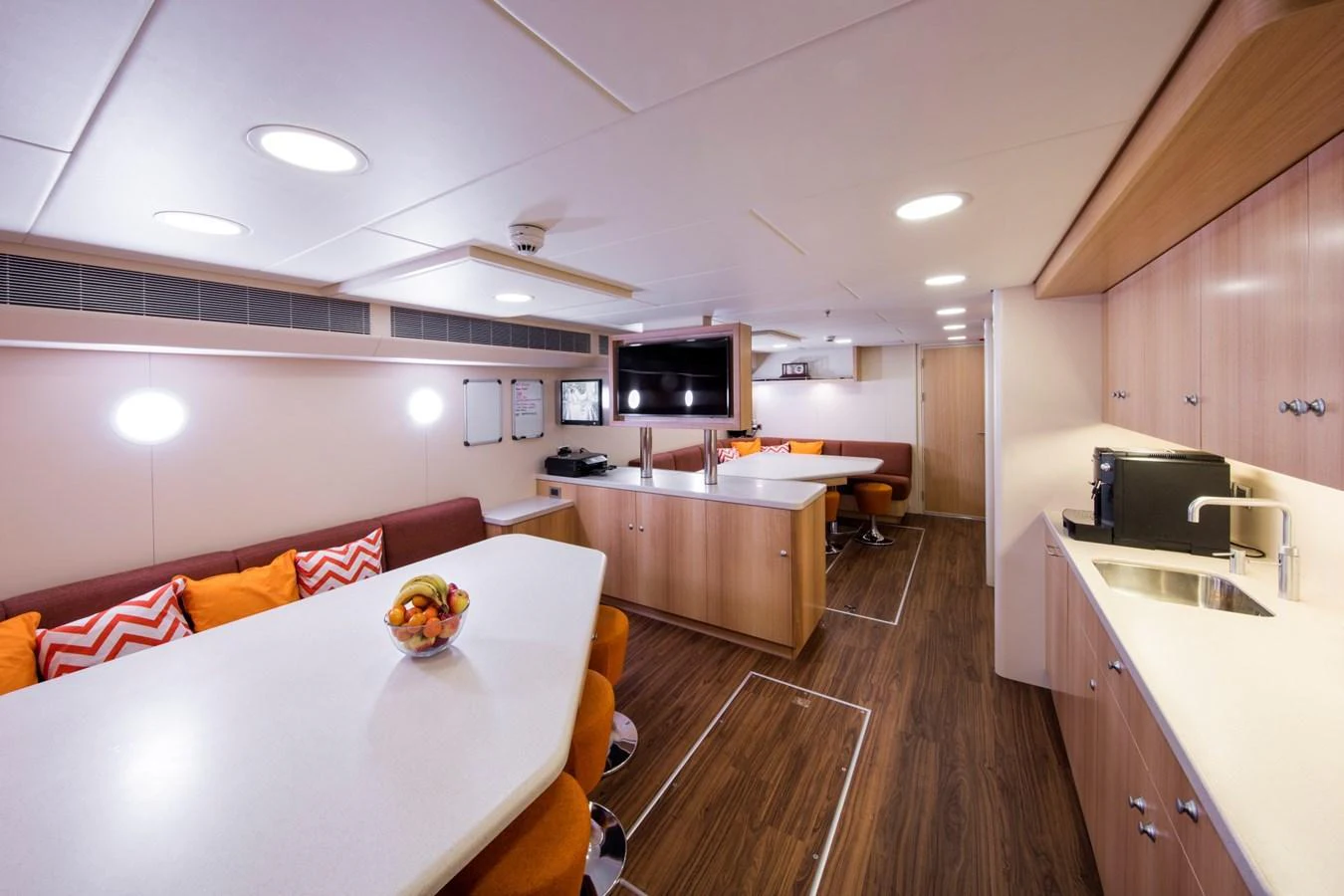 The yacht's galley features modern amenities and a spacious dining area with a warm, inviting atmosphere. aboard JUST J'S Yacht for Sale