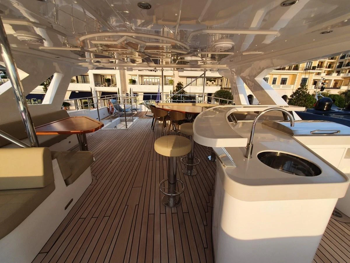 The flybridge features a spacious seating area and a well-equipped bar, perfect for entertaining guests. aboard AMORE Yacht for Sale