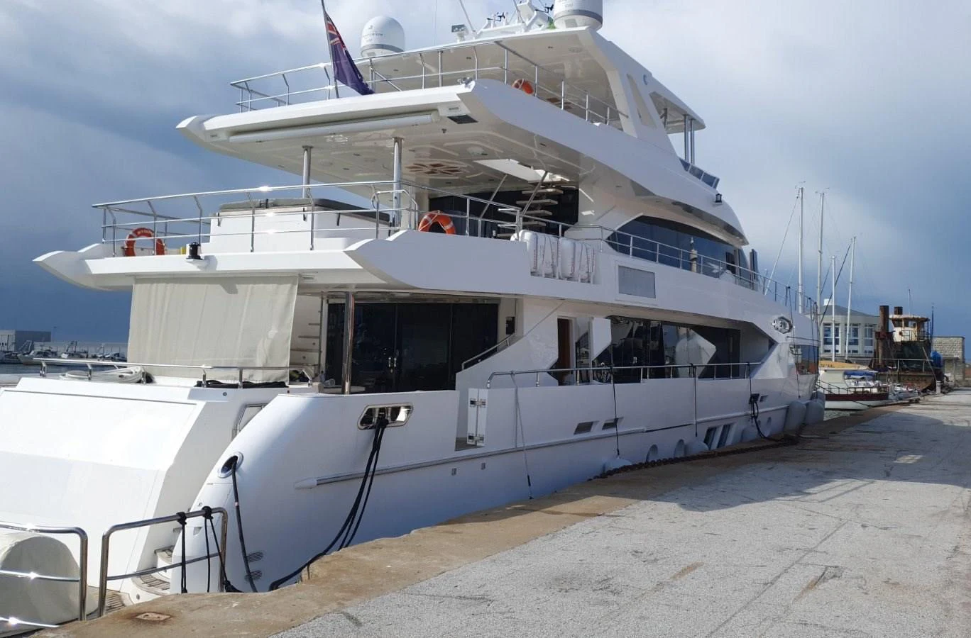 A luxurious yacht is docked at the marina, showcasing its sleek and modern design. aboard AMORE Yacht for Sale