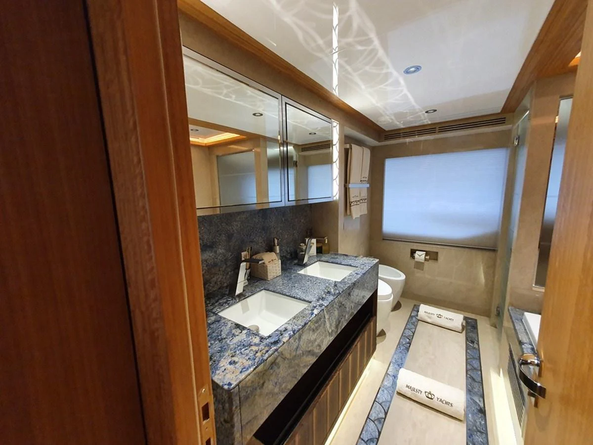 The yacht's bathroom features a luxurious double sink vanity with elegant stone countertops and modern fixtures. aboard AMORE Yacht for Sale
