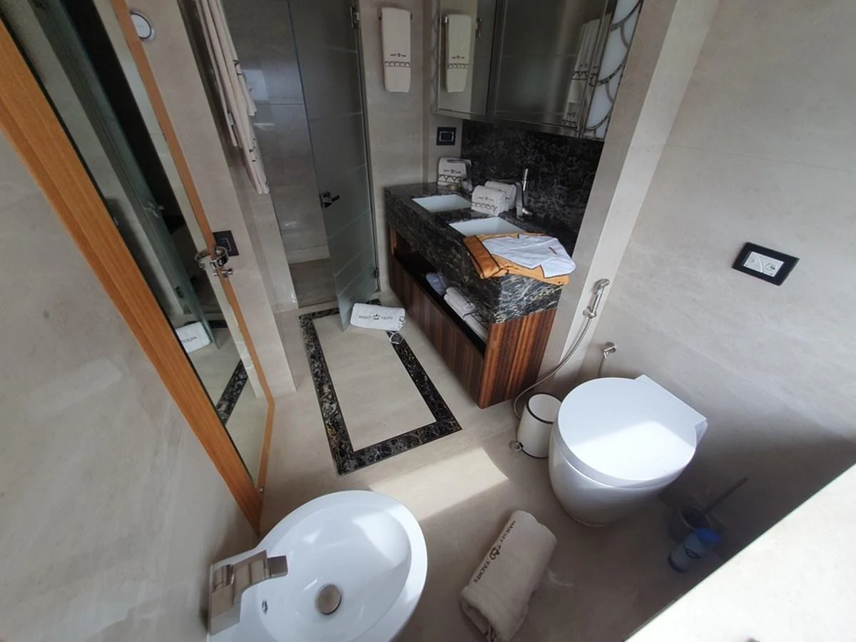 A well-appointed yacht bathroom with modern fixtures and elegant finishes. aboard AMORE Yacht for Sale