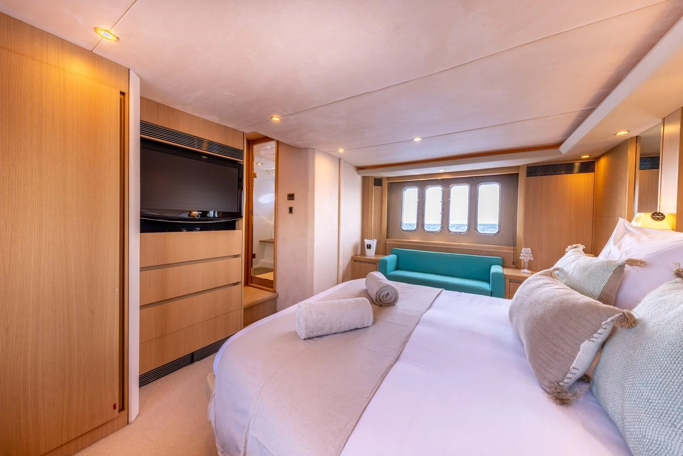 a bedroom with a bed and a television aboard P'TITE BOUILLE Yacht for Sale