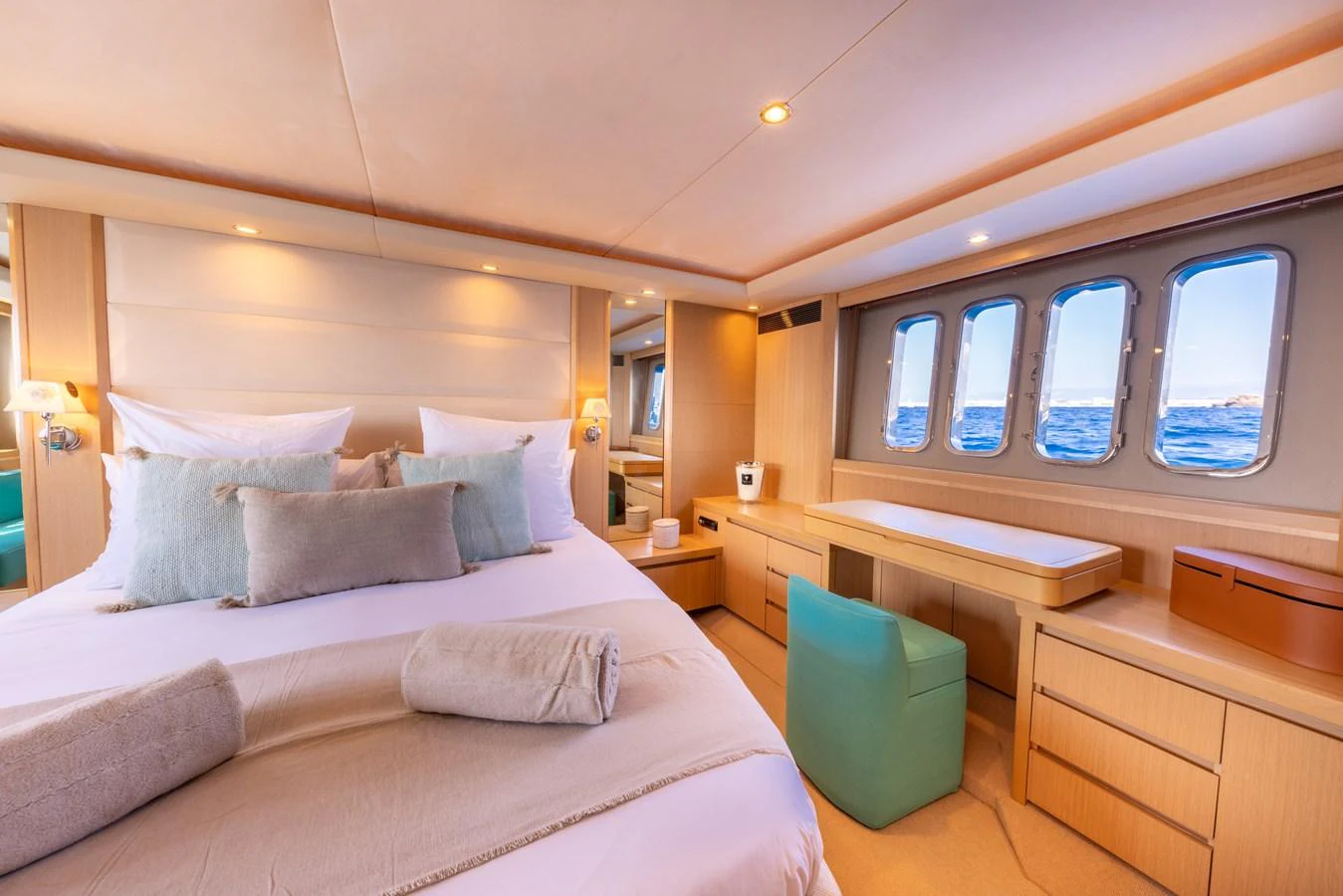a bed with a white bed spread aboard P'TITE BOUILLE Yacht for Sale