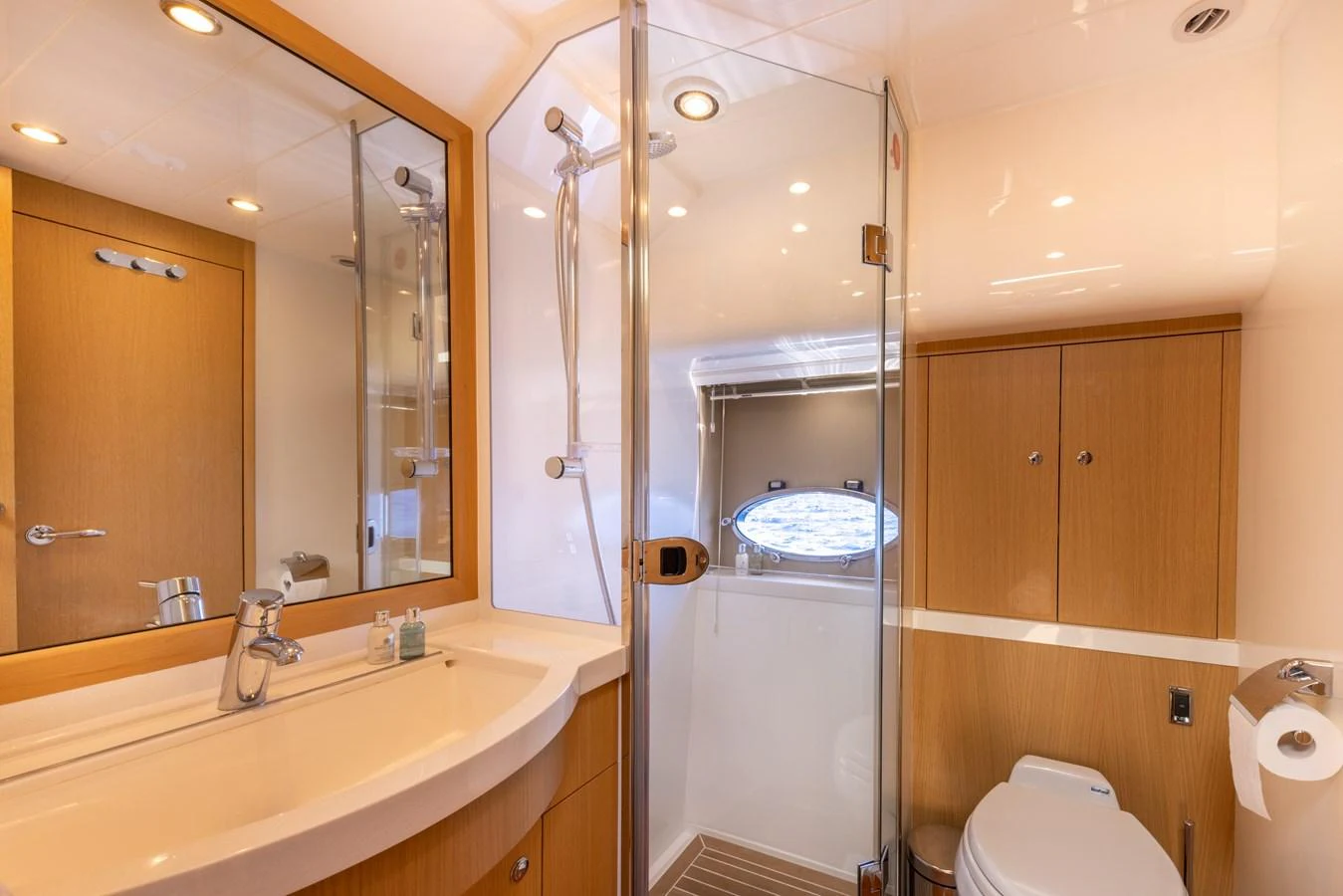 a bathroom with a large mirror aboard P'TITE BOUILLE Yacht for Sale