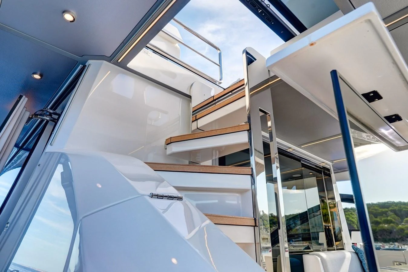 A sleek and modern staircase leads to the upper deck, showcasing the yacht's elegant design. aboard APRICITY Yacht for Sale