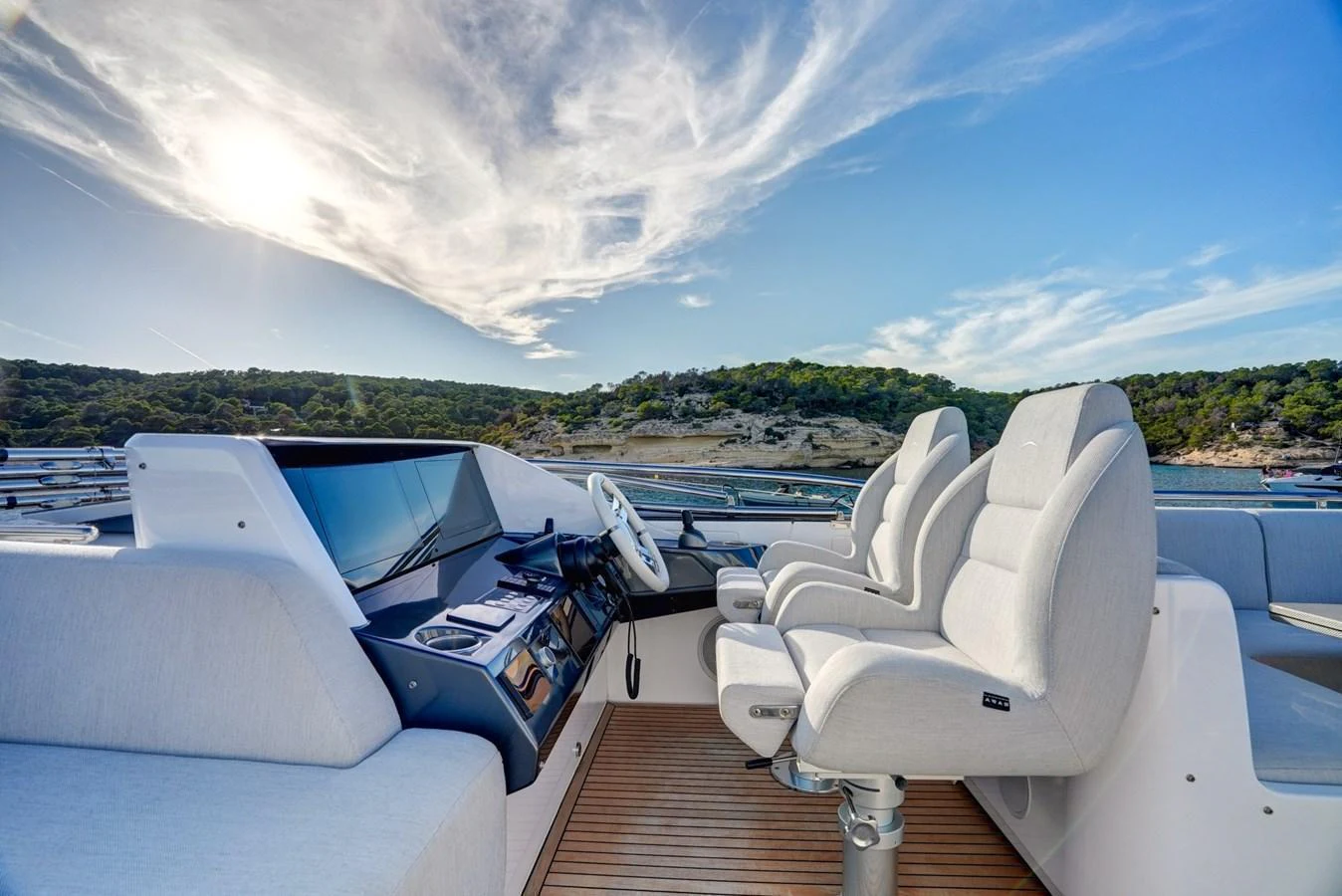 The helm station offers a commanding view with plush seating and state-of-the-art controls. aboard APRICITY Yacht for Sale