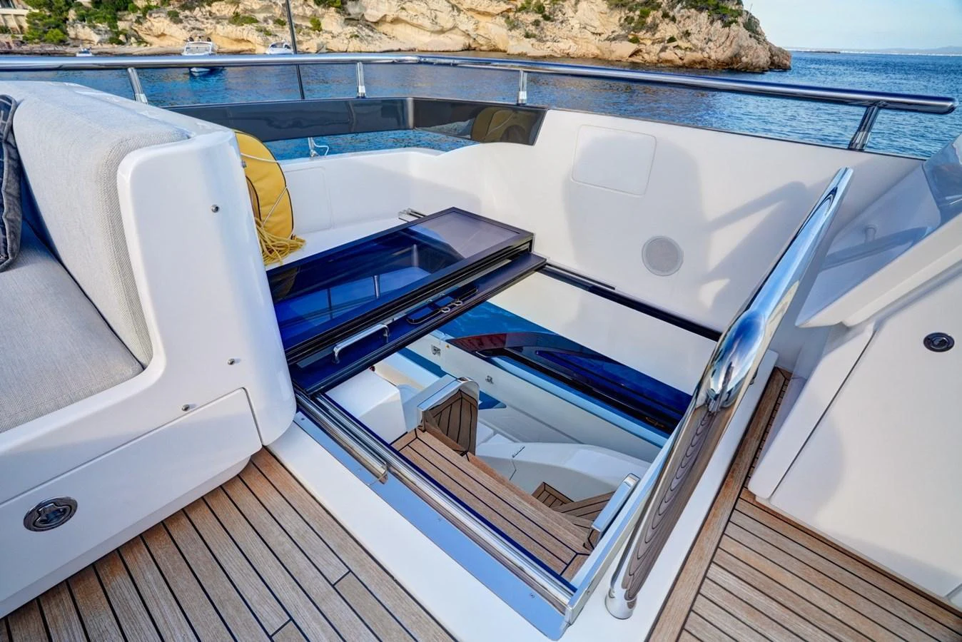 A sleek staircase with a glass hatch leads from the deck to the interior of the yacht. aboard APRICITY Yacht for Sale