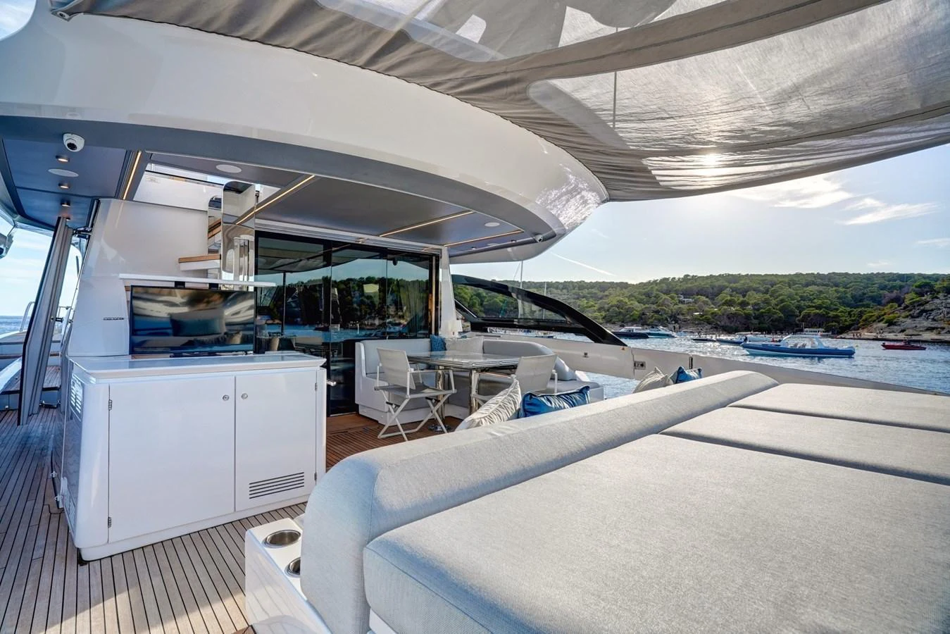 The aft deck offers a luxurious outdoor lounging area with comfortable seating and stunning views of the surrounding waters. aboard APRICITY Yacht for Sale